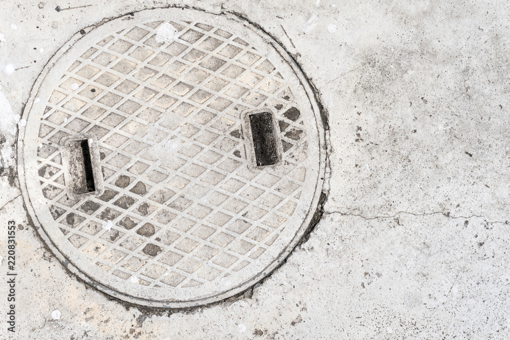 white concrete and manhole cover Drain texture background white concrete and manhole cover Drain texture background