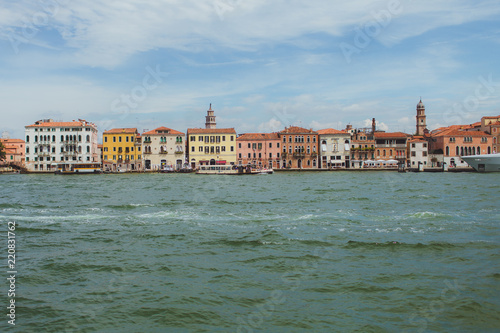 Venetian channel view at the city in one horizontal line of urban architecture  buildings  one of the Venice Bridge  free space