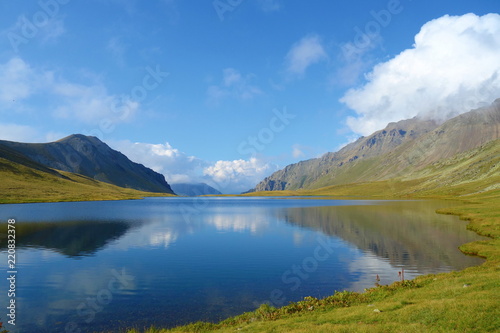 Black Rock Lake with reflections of surrounding mountains in Lagodekhi national park located in Caucasus mountains, Northern Georgia