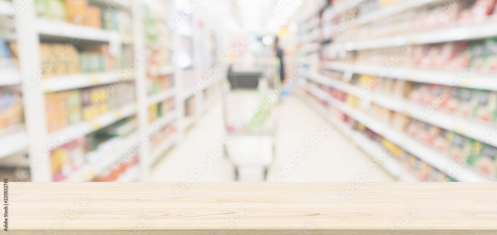 Wood table top with supermarket aisle blur background for product display