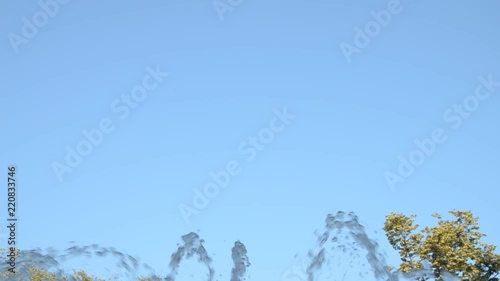 Water jets from a fountain changing shapes of spraying up in the air