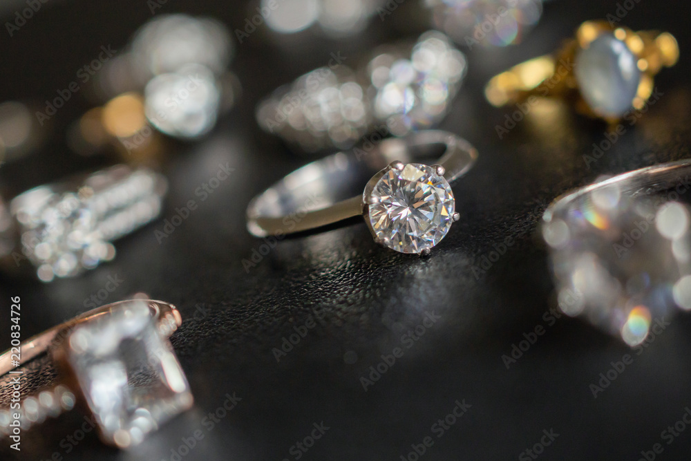 Jewelry diamond rings on black background close up Jewelry diamond rings on black background close up