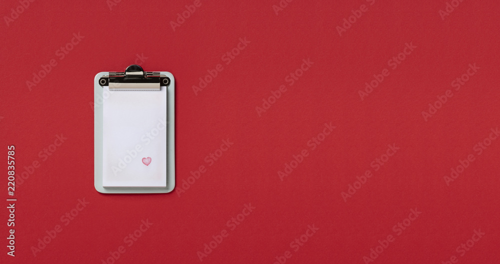 Clipboard on red horizontal background. Flat lay, top view trendy for banner with heart Clipboard on red horizontal background. Flat lay, top view trendy for banner with heart