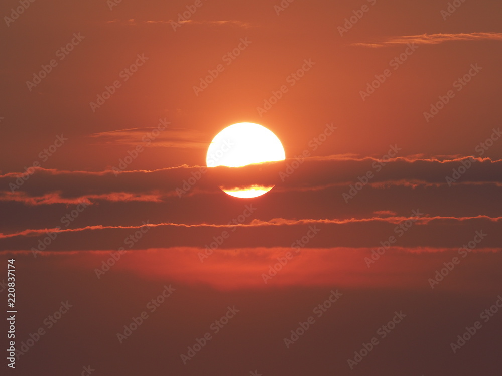 Colored sun set with clouds formation seen in summer evening from european city in Poland on July 2018