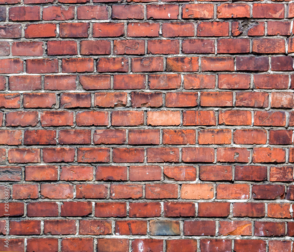 Obraz premium The texture of the old clinker brick wall with a white seam. Close-up.