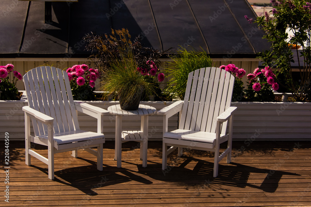 white wooden garden furniture, table and two armchairs. city cafe terrace. Stockholm, Sweden white wooden garden furniture, table and two armchairs. city cafe terrace. Stockholm, Sweden
