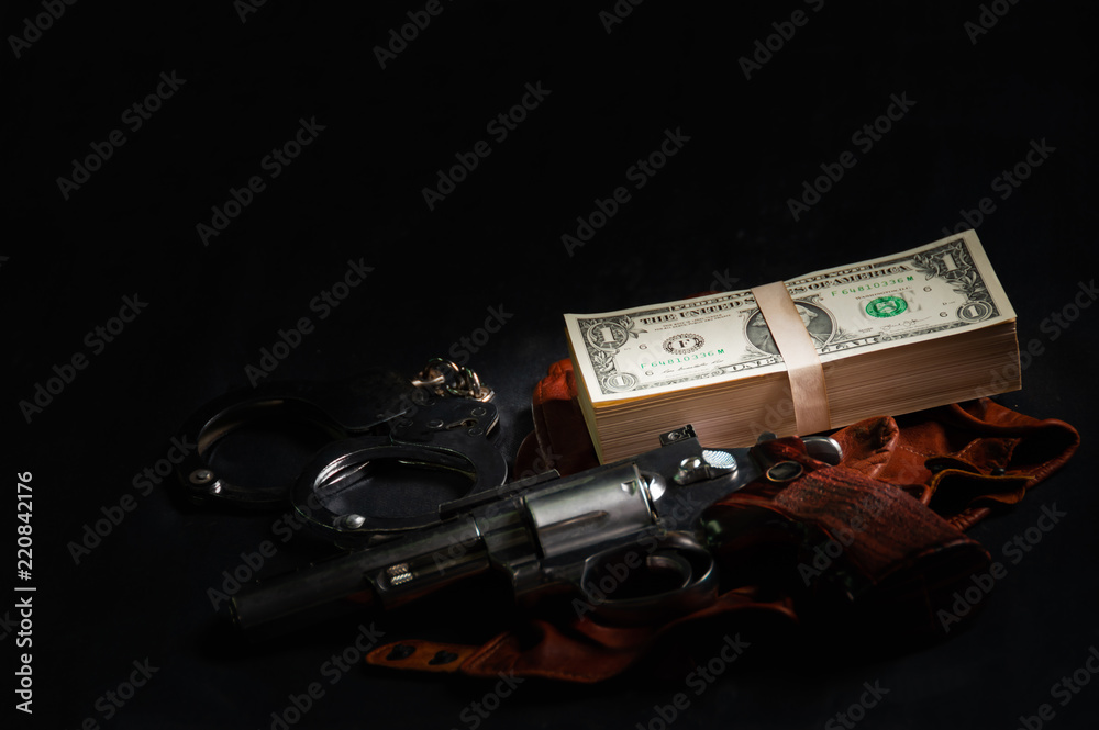 Dollar banknotes, shackles and carbiines with black background, to Dark
