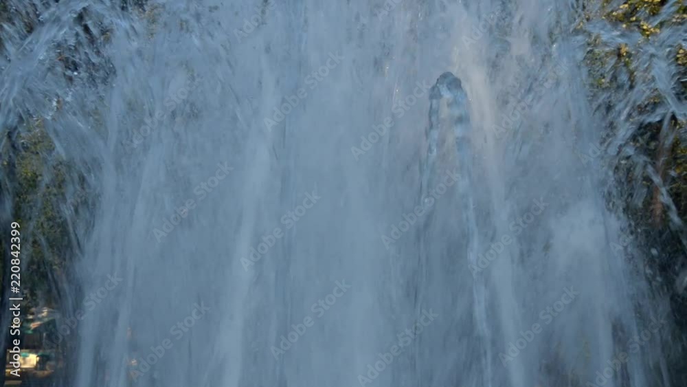 Tilt-up shot of water jets from a fountain spraying up and changing shapes in a public park of Vrnjacka Banja, Serbia. Jets stop spraying water before the end of the footage. Tilt-up shot of water jets from a fountain spraying up and changing shapes in a public park of Vrnjacka Banja, Serbia. Jets stop spraying water before the end of the footage.