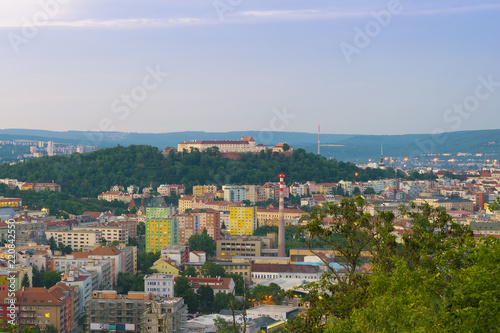 Aerial evening view on Brno city, houses skyscrapers and fortress Spilberk from hill. Beautiful panorama around exhibition centre, colorful houses and roofs.