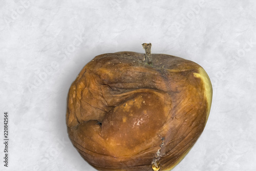 Картината върху платно Old brown rotten apple on isolated background