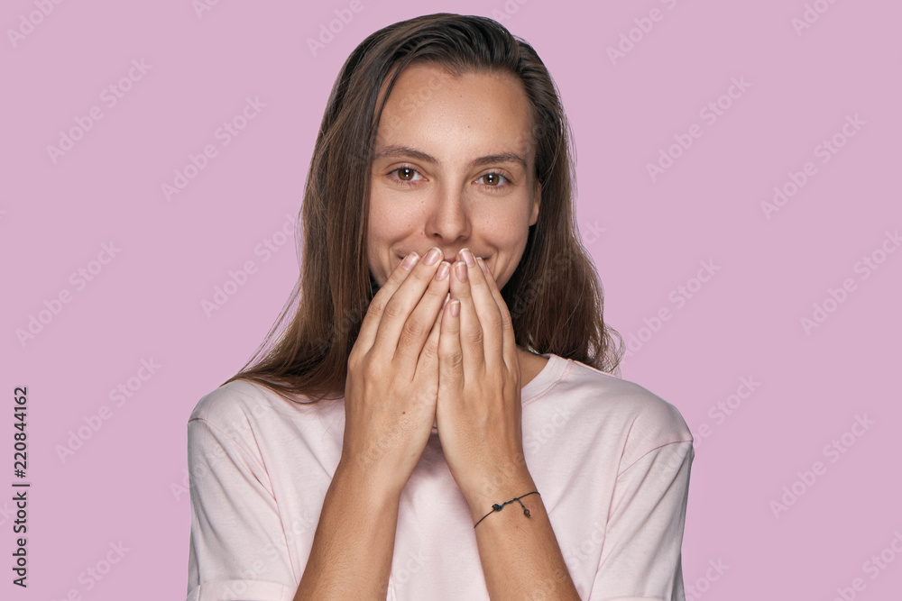 Beautiful excited female covers eyes with happiness, doesn't expect to receive pleasant surprise from close friend, being thankful and pleasantly shocked, isolated over lavender background Beautiful excited female covers eyes with happiness, doesn't expect to receive pleasant surprise from close friend, being thankful and pleasantly shocked, isolated over lavender background