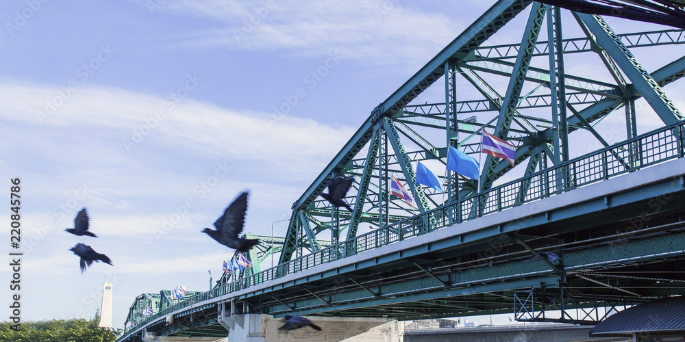 Obraz premium Phra Phuttha Yodfa Bridge, Memorial Bridge in Thailand.Morning light cloudy and blue sky.Copy right and panorama.