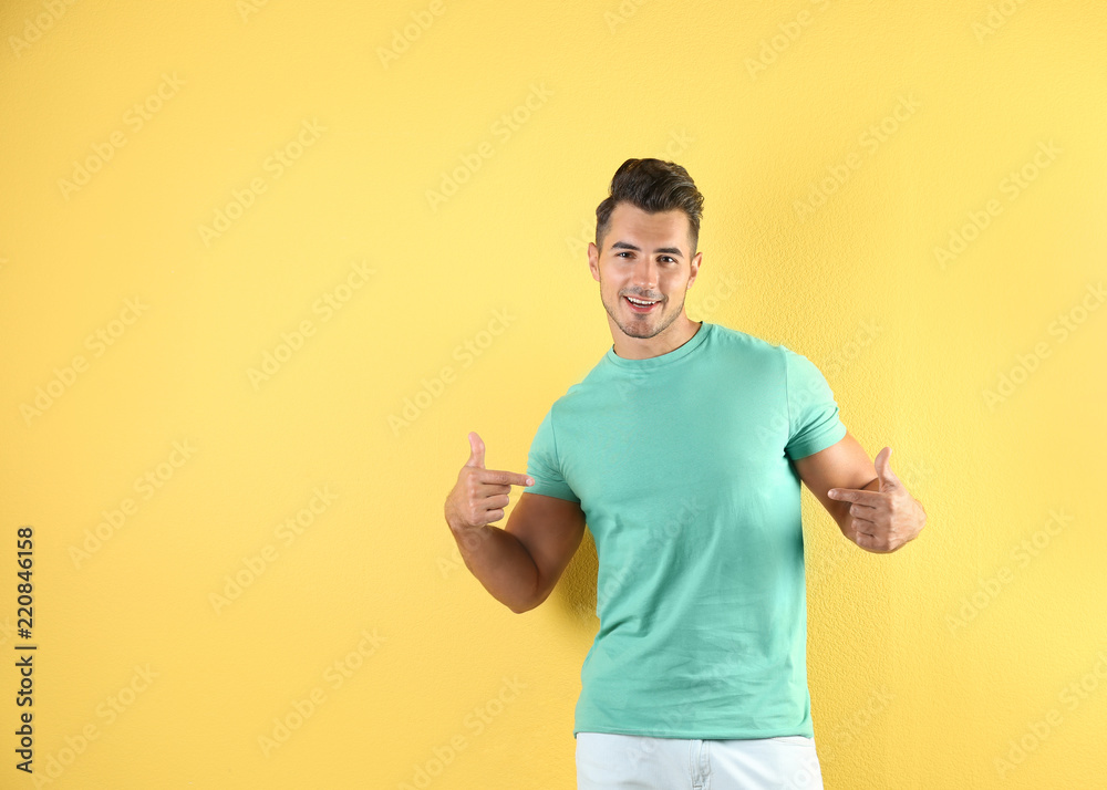Young man in t-shirt on color background. Mockup for design Young man in t-shirt on color background. Mockup for design