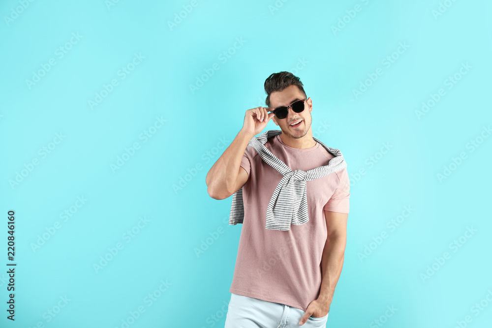 Young man in stylish jeans on color background Young man in stylish jeans on color background