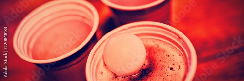 Tableau sur toile Close-up of pong ball on beer glass