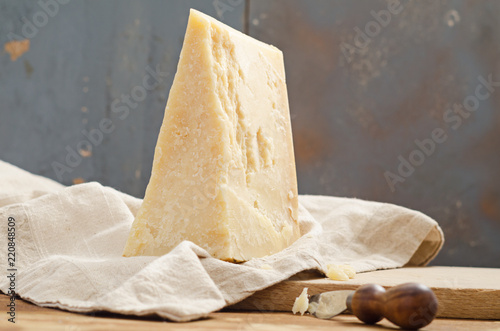 Parmesan cheese on wooden table with copyspace.