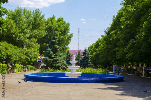 City park and fountain without water in the foreground. photo