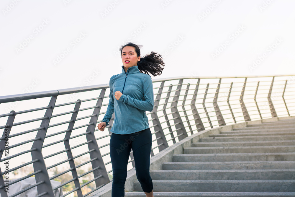 Girl running on the staircase outdoors