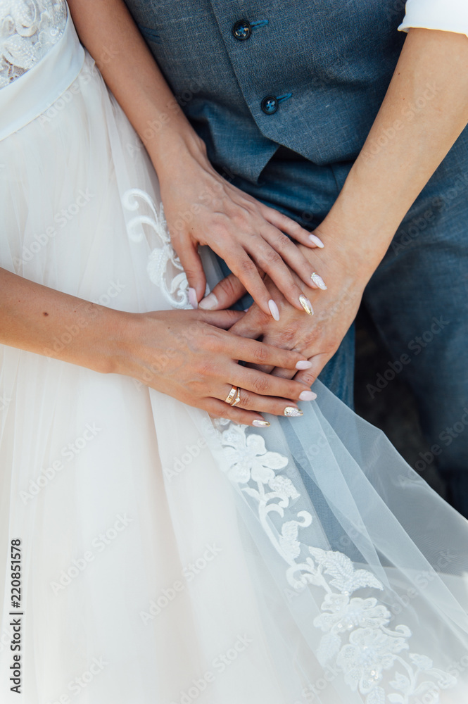 Bride and groom are hugging during the day Bride and groom are hugging during the day