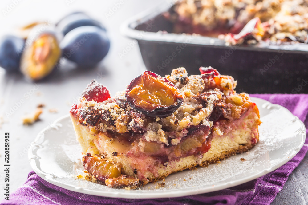The traditional sweet plum cake on white plate The traditional sweet plum cake on white plate