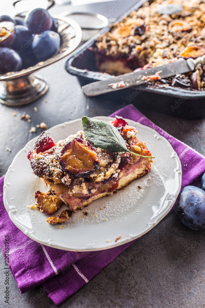 The traditional sweet plum cake on white plate The traditional sweet plum cake on white plate