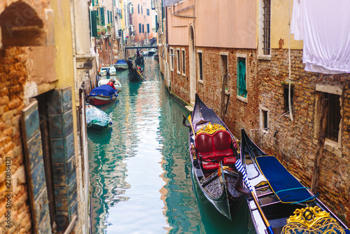 Venetian channel with ancient houses and boats © teksomolika