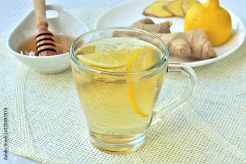Ginger tea with honey and lemon, homemade nausea remedy.