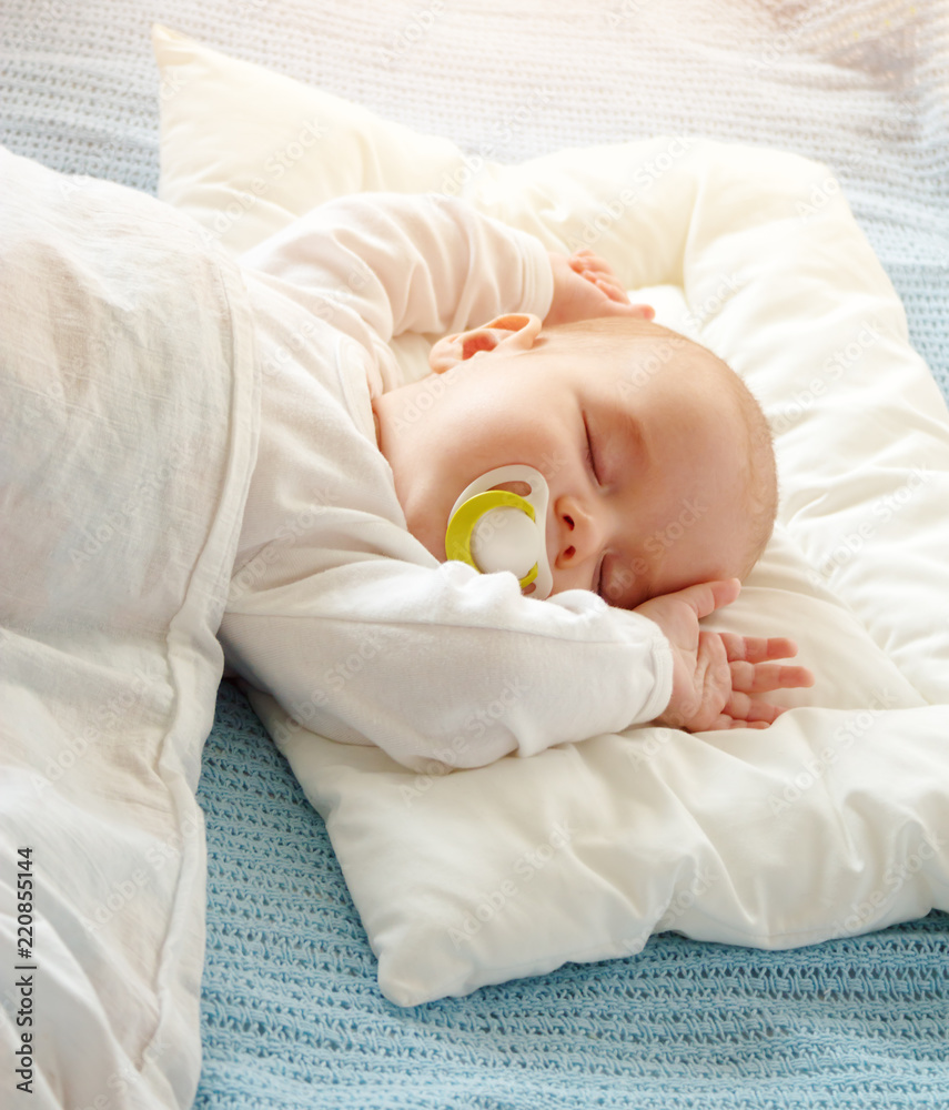 Baby sleeping covered with soft white blanket Baby sleeping covered with soft white blanket