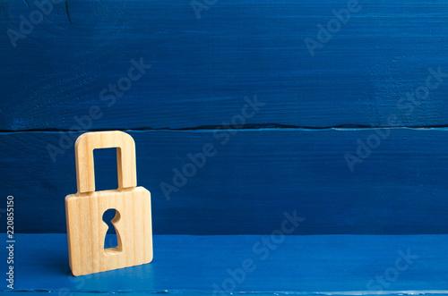 a wooden padlock on a blue background, information, entrance. concept of the preservation of secrets, information and values. Protection of data and personal information. Hacking attack, hacking photo