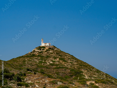 Lighthouse is located on a high point of the island near the ruins of the ancient city of Knidos  cloudless sky in sunny day at the confluence of two seas - Mediterranean sea and Aegean sea  Turkey