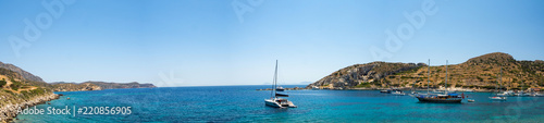 Picturesque bay between the Datca Peninsula and the island of Knidos, indented coastline between of mediterranean and aegean seas with beautiful turquoise water, sailboat in the middle, Turkey