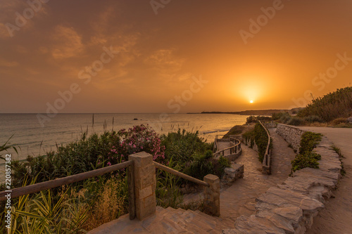 View of the beach of Fuente del Gallo with the lighthouse of Cape Roche in the background, in Conil, Andalucia. Spain