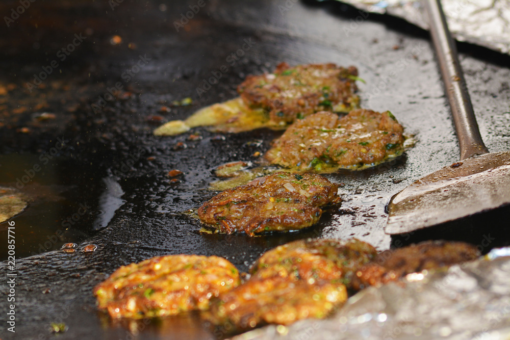 Mughlai Food Tikki kabab getting fried in a large pan Mughlai Food Tikki kabab getting fried in a large pan