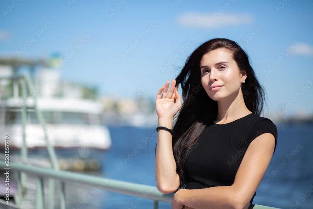 Adorable brunette model enjoying warm weather, posing at the river. Space for text Adorable brunette model enjoying warm weather, posing at the river. Space for text