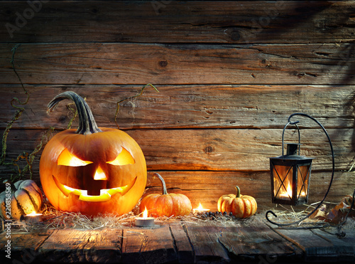 Halloween Pumpkins In Rustic Background With Lantern

