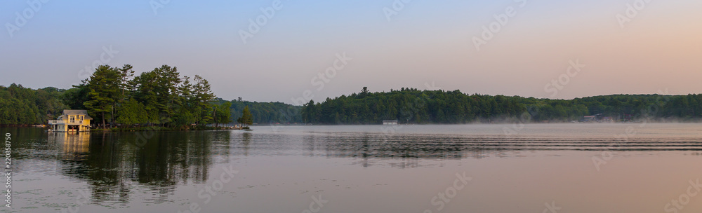 A small lakeside cottage on an Island in the Muskokas, Ontario, at sunrise.