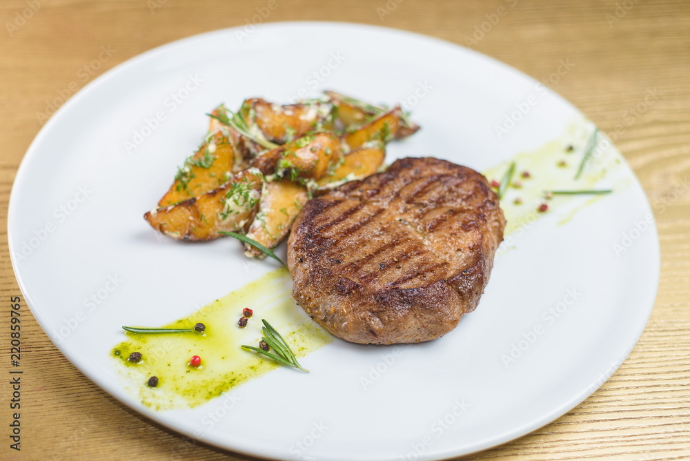 steak with baked potatoes on a white plate steak with baked potatoes on a white plate