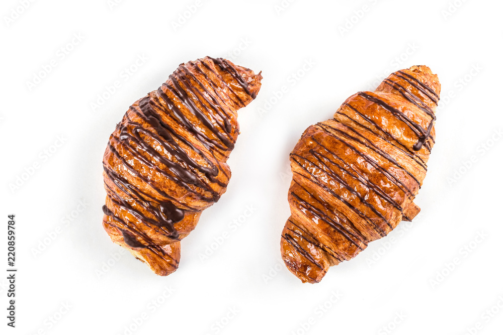 Two chocolate croissant on white background, top view