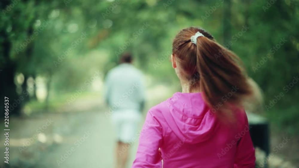 A girl and a man are engaged in a sport A girl and a man are engaged in a sport