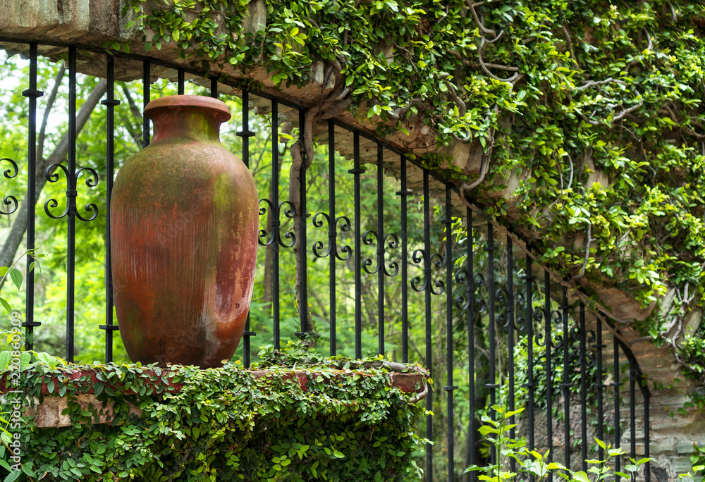 Clay pitcher pot and metal bars in colonial mexican garden in San Gabriel Barrera Guanajuato