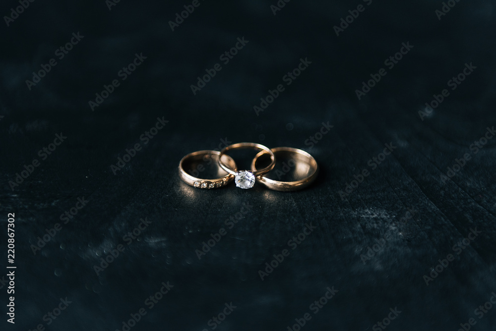 Wedding rings arranged on the black wooden table. Wedding card, Valentine Wedding rings arranged on the black wooden table. Wedding card, Valentine