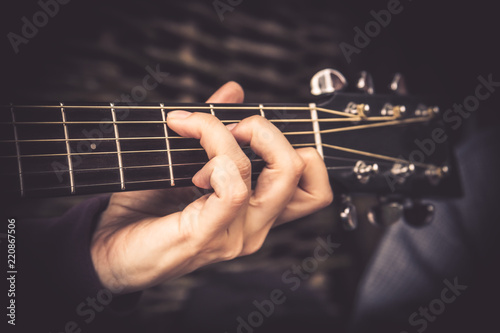 Tableau sur toile Guitarist Playing song on acoustic guitar fretboard chord vintage style