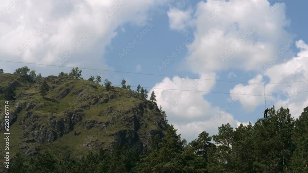 Trolley -Zip-Line- over the valley in mountains Trolley -Zip-Line- over the valley in mountains