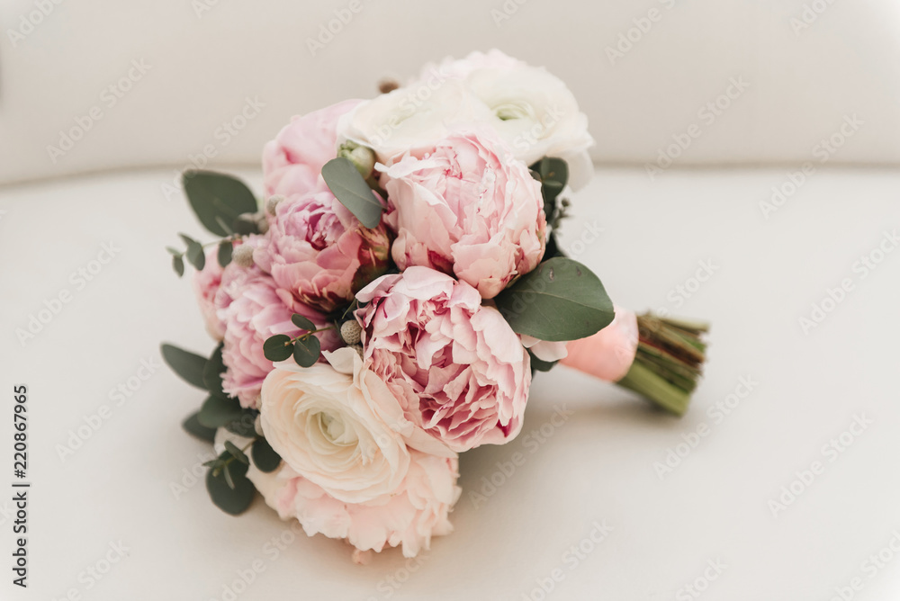 Beautiful wedding bouquet for the bride with pink peonies and white peony roses