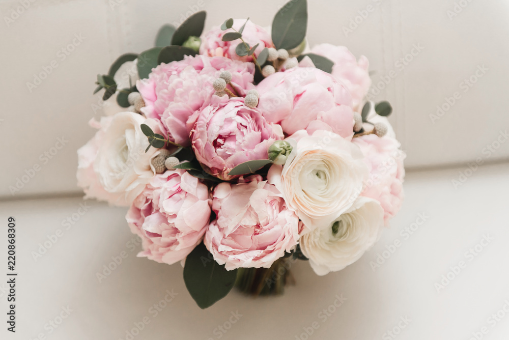 Beautiful wedding bouquet for the bride with pink peonies and white peony roses