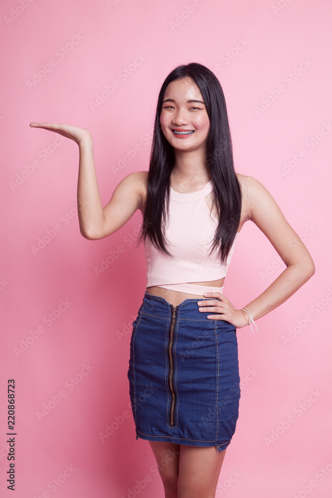 Young Asian woman present with her hand. Young Asian woman present with her hand.