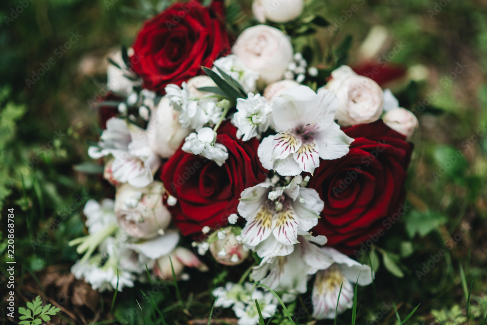 Beautiful wedding bouquet for the bride with red and white roses and eustoma Beautiful wedding bouquet for the bride with red and white roses and eustoma