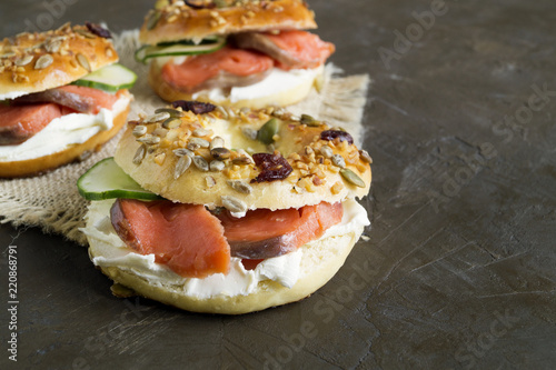 Bagels with cream cheese and smoked salmon on a black background