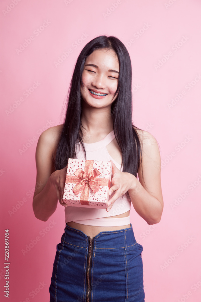 Young Asian woman with a gift box. Young Asian woman with a gift box.