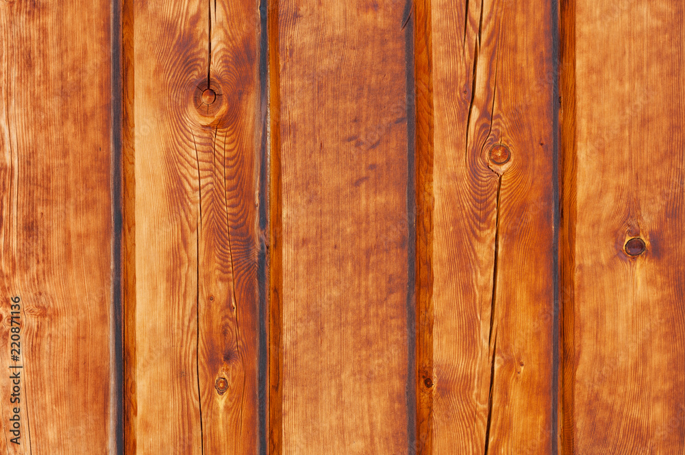 vertical wooden planks on the wall, bright brown texture vertical wooden planks on the wall, bright brown texture